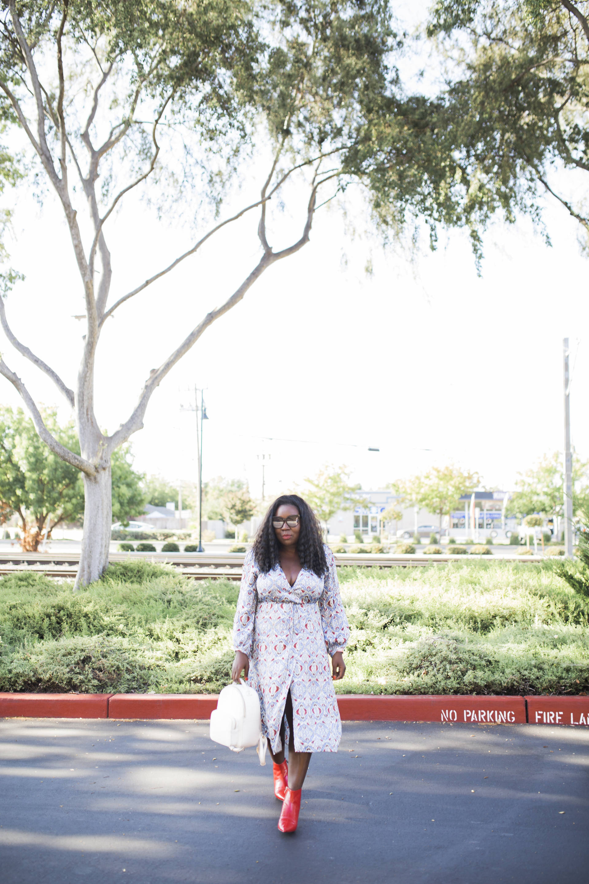 Trend Alert: Red Boots! Pairing the red hot trend with a silk dress and white bag! 